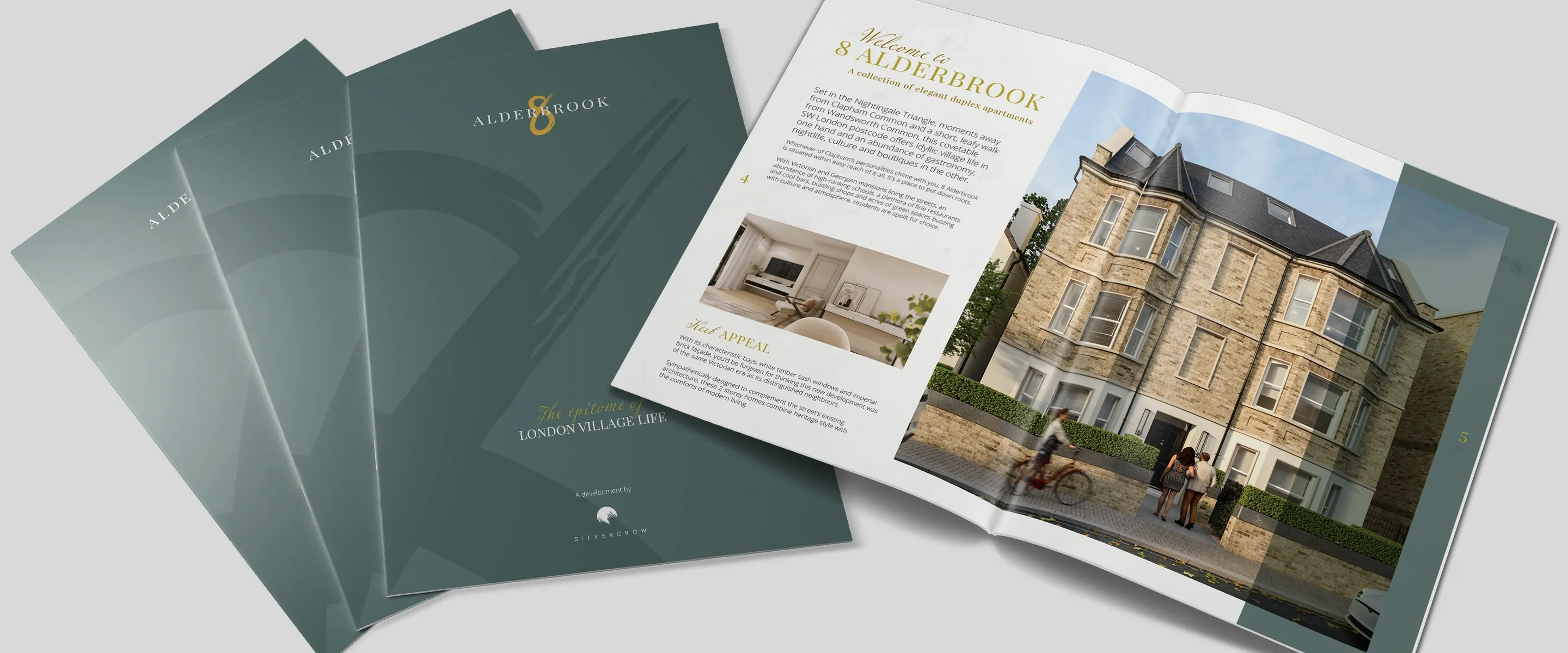 Three 8 Alderbrook sales brochures for Silvercrow fanned out, with sage green covers and a gold figure-8 logo, beside one open at the Welcome to 8 Alderbrook spread with a CGI of the Victorian-style facade