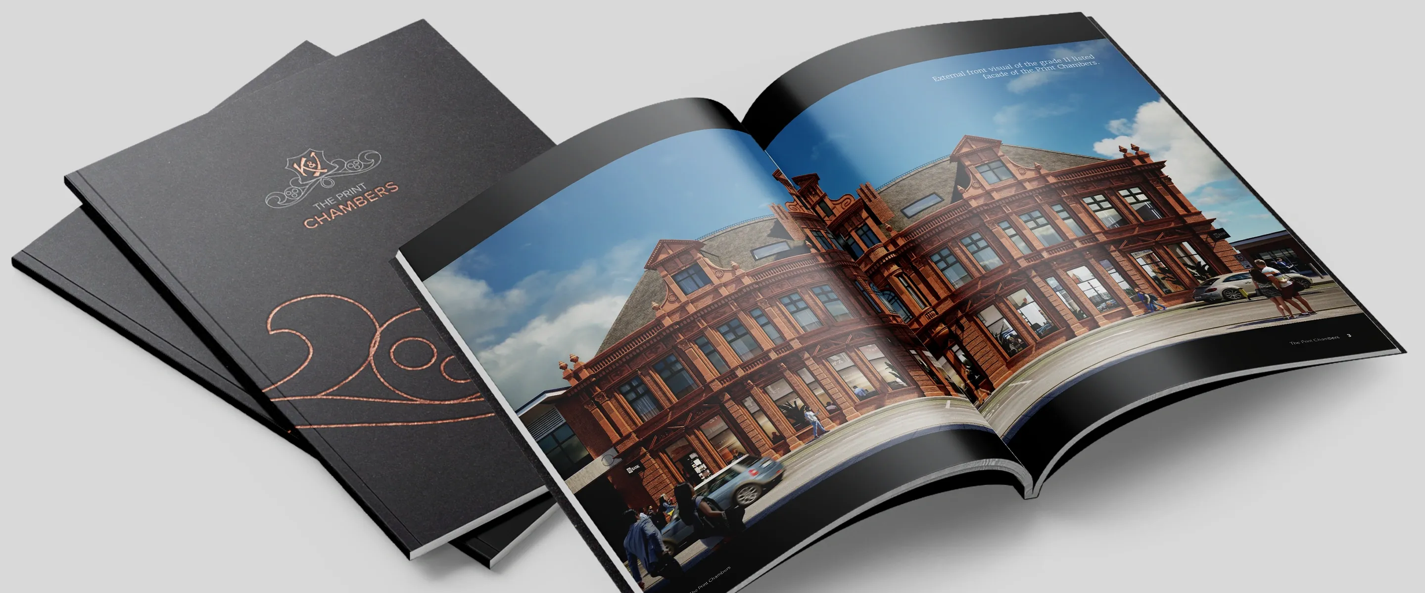 The Print Chambers sales brochure for Detail DMC: closed cover with copper monogram beside an open spread of the red terracotta facade