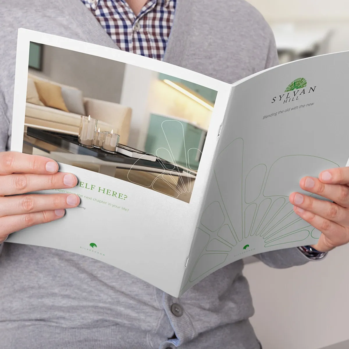 Sylvan Hill brochure held open at its back and front covers, with an interior CGI and the strapline Blending the old with the new